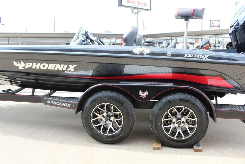 Slide: The Image of 2026 Phoenix 920 Elite X boat on trailer, featuring sleek design and dual wheels. - 6