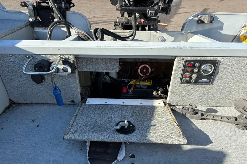 Slide: The Image of 2015 Smoker Craft Freedom 160 TL boat interior with control panel and battery compartment. - 11