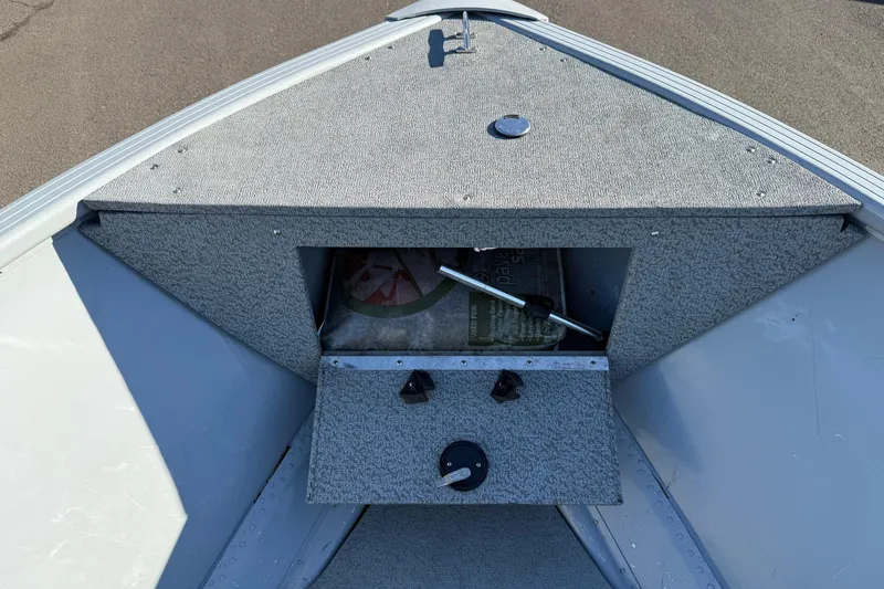 Slide: The Image of 2015 Smoker Craft Freedom 160 TL boat storage compartment with open hatch. - 14