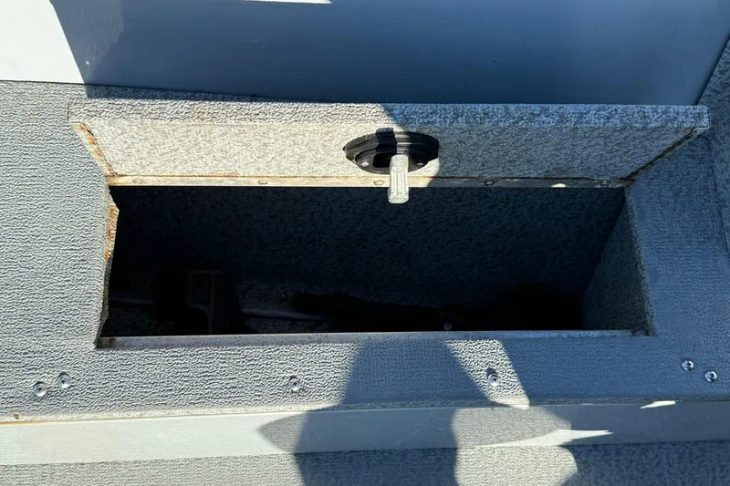 Slide: The Image of Open storage compartment on 2015 Smoker Craft Freedom 160 TL boat. - 16
