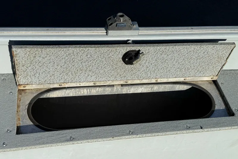 Slide: The Image of Open storage compartment on a 2015 Smoker Craft Freedom 160 TL boat. - 20