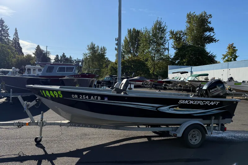 Slide: The Image of 2015 Smoker Craft Freedom 160 TL boat on trailer, parked outdoors. - 3