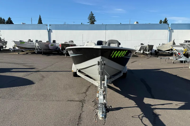 Slide: The Image of 2015 Smoker Craft Freedom 160 TL boat on trailer, priced at $14,495, in a parking lot. - 5