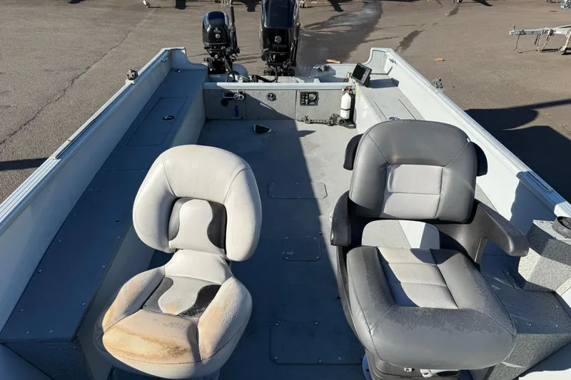 Slide: The Image of 2015 Smoker Craft Freedom 160 TL boat interior with two seats and dual motors. - 6