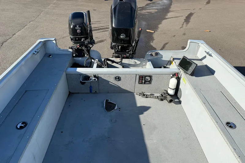 Slide: The Image of 2015 Smoker Craft Freedom 160 TL boat interior with dual motors and control panel. - 8