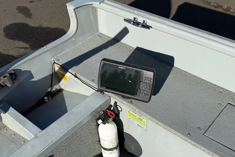Slide: The Image of 2015 Smoker Craft Freedom 160 TL boat interior with Garmin device and fire extinguisher. - 9