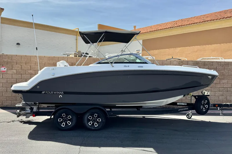 The Image of 2023 Four Winns HD3 boat on trailer, parked outdoors with a canopy. - 0