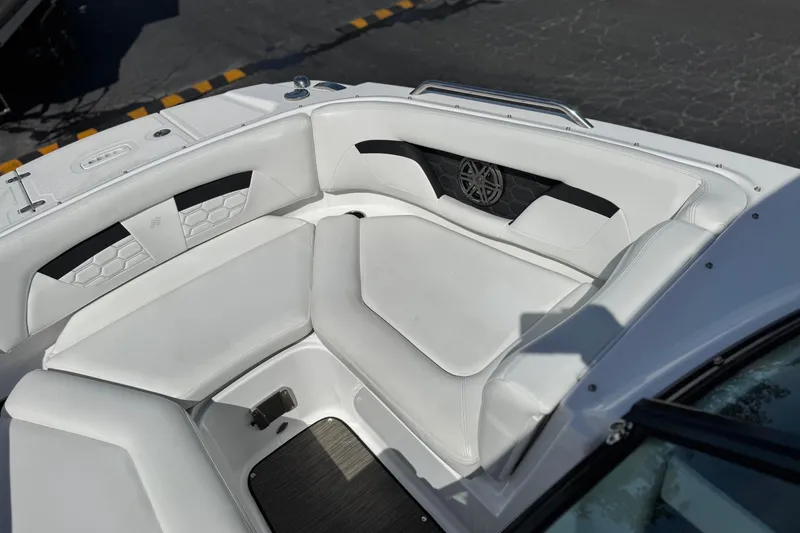 Slide: The Image of 2023 Four Winns HD3 boat interior with white cushioned seating and speaker detail. - 17