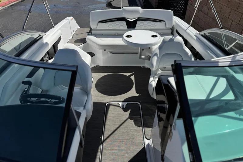 Slide: The Image of 2023 Four Winns HD3 boat interior with white seating and a round table. - 20