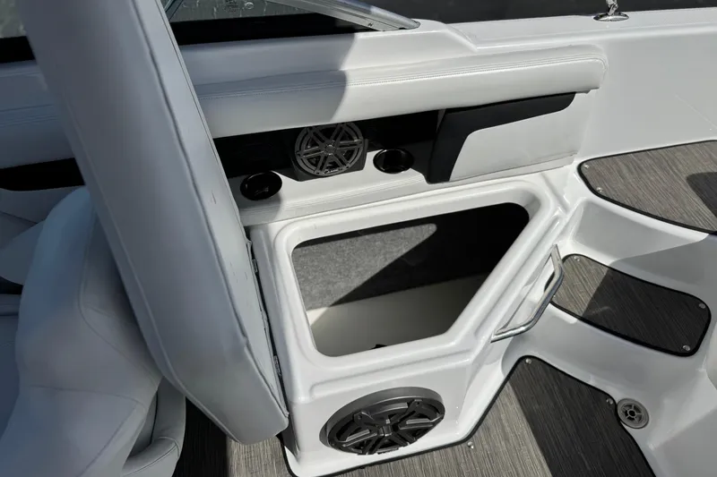 Slide: The Image of 2023 Four Winns HD3 boat interior with storage compartment and speaker system. - 23