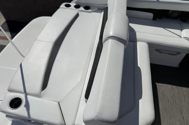 Slide: The Image of 2023 Four Winns HD3 boat interior seating with cup holders, showcasing luxury design. - 25