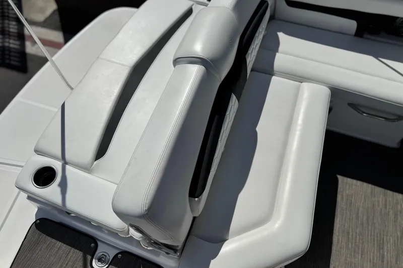 Slide: The Image of 2023 Four Winns HD3 boat interior with sleek white seating and cup holder. - 26