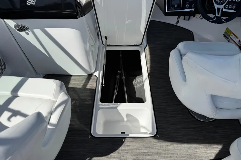Slide: The Image of 2023 Four Winns HD3 boat interior with open storage compartment and white seating. - 29