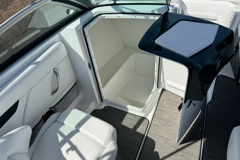 Slide: The Image of 2023 Four Winns HD3 boat interior with open storage compartment and seating. - 31