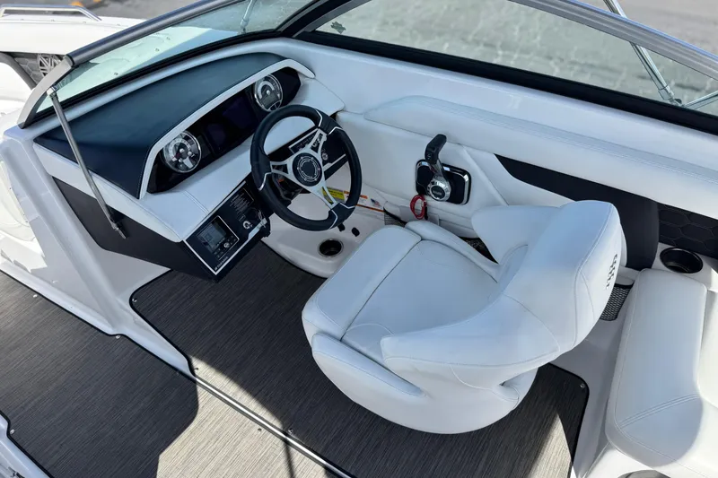 Slide: The Image of 2023 Four Winns HD3 boat interior with steering wheel and white captain's chair. - 33