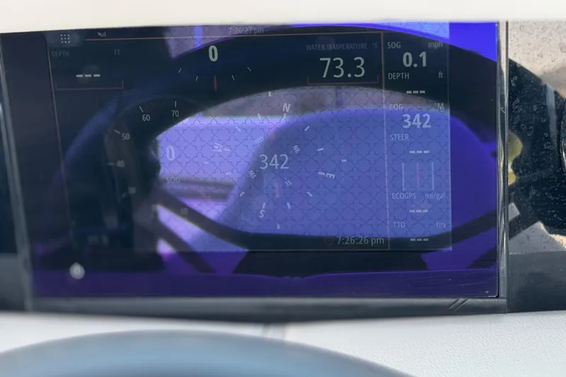 Slide: The Image of Dashboard display of 2023 Four Winns HD3 boat showing navigation and water temperature. - 37