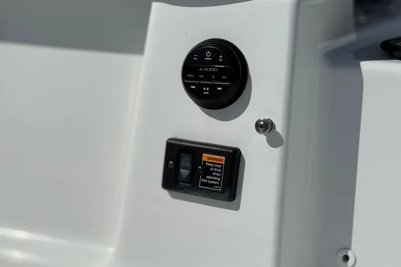 Slide: The Image of Control panel of 2023 Four Winns HD3 boat with audio system and warning label. - 7