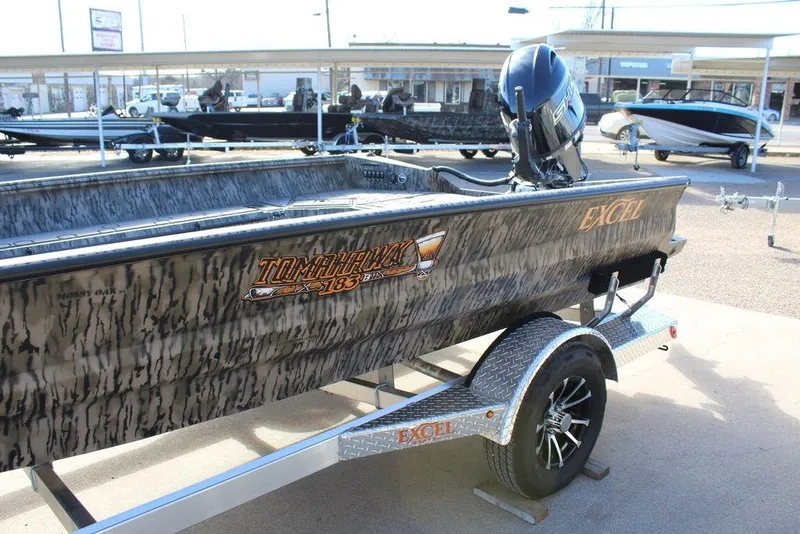 Slide: The Image of 2026 Excel 183 Tomahawk boat with camouflage design on a trailer. - 12