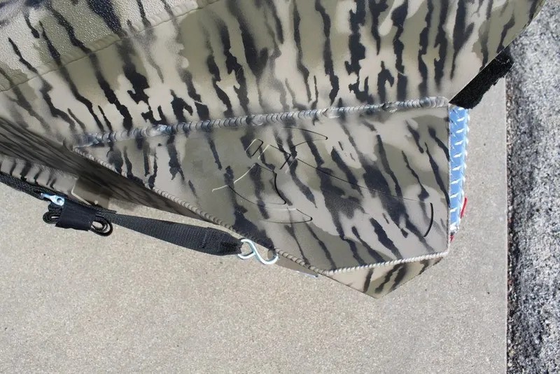 Slide: The Image of Camouflage-patterned Excel 183 Tomahawk boat detail, 2026 model, with visible stitching and hardware. - 13