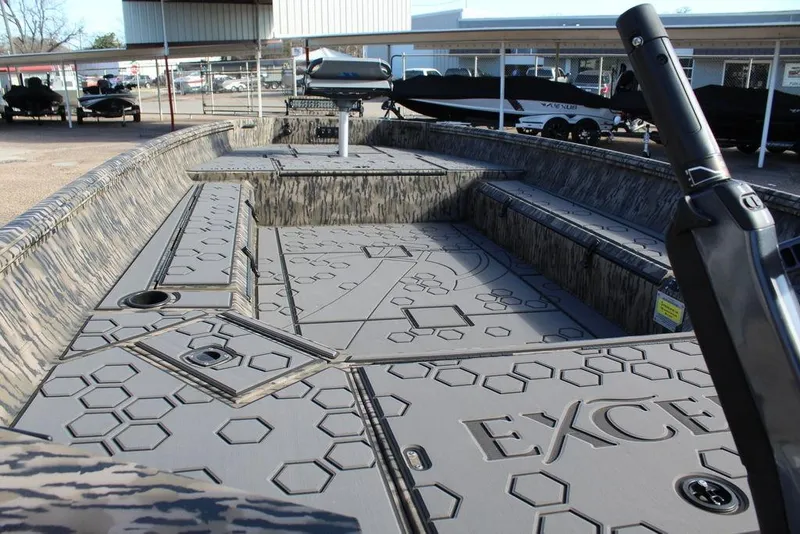 Slide: The Image of 2026 Excel 183 Tomahawk boat interior with hexagonal pattern and camo design. - 15