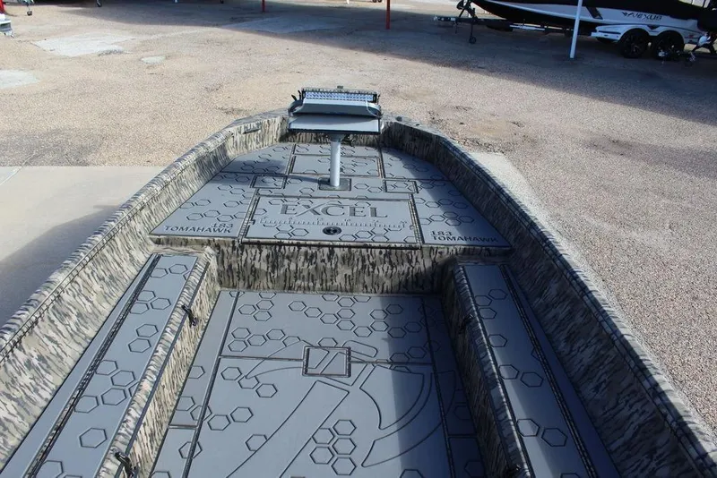 Slide: The Image of 2026 Excel 183 Tomahawk boat interior with hexagonal pattern and camouflage design. - 18