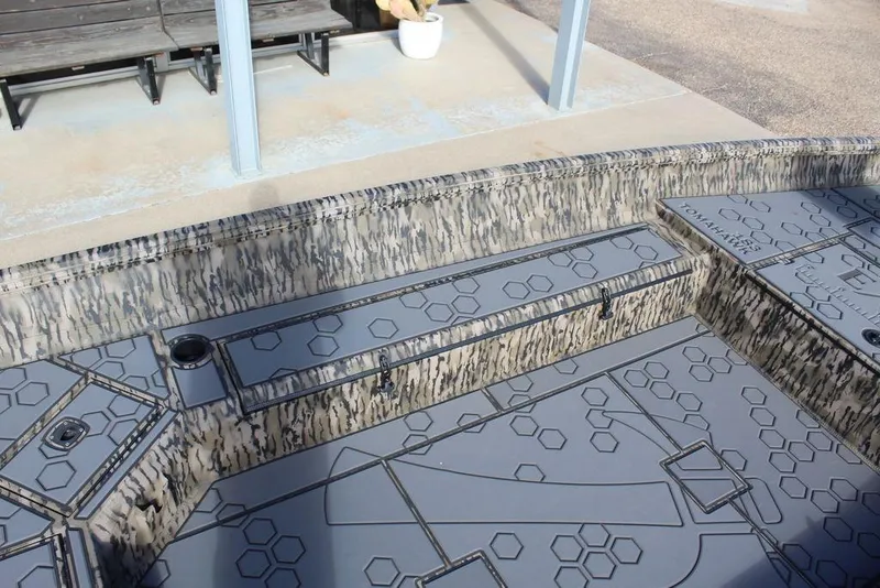 Slide: The Image of Interior view of 2026 Excel 183 Tomahawk boat with patterned flooring and seating. - 19