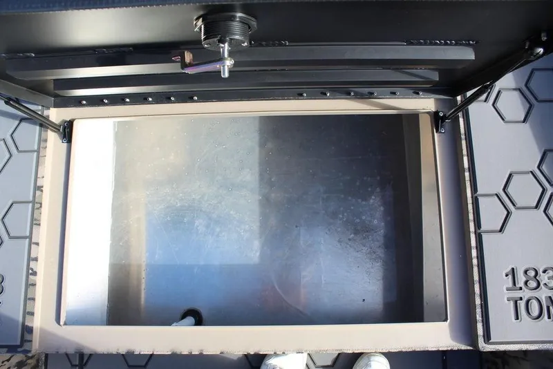 Slide: The Image of Open storage compartment of Excel 183 Tomahawk, 2026 model, with hexagonal pattern design. - 20