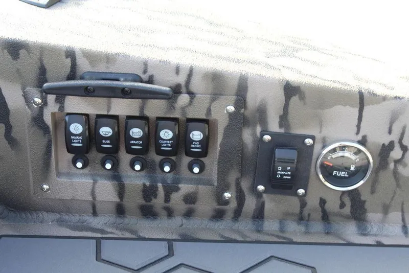 Slide: The Image of Control panel of Excel 183 Tomahawk 2026 boat with switches and fuel gauge. - 21