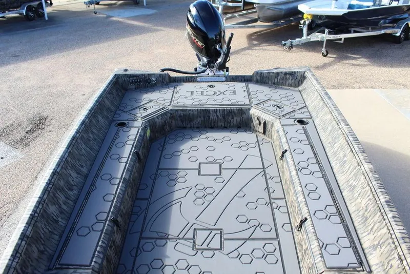 Slide: The Image of 2026 Excel 183 Tomahawk boat interior with hexagonal pattern and motor. - 23