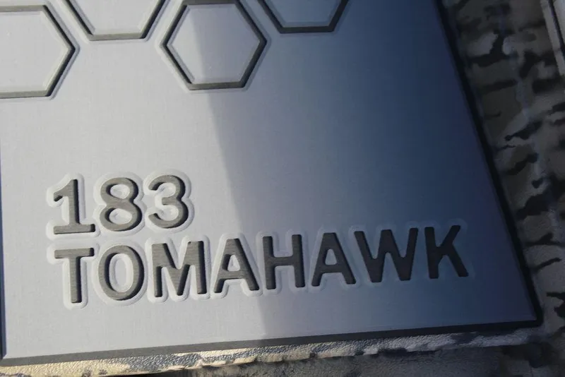Slide: The Image of Excel 183 Tomahawk 2026 model nameplate with hexagonal design elements. - 24