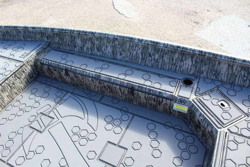 Slide: The Image of 2026 Excel 183 Tomahawk boat interior with hexagonal pattern and camouflage design. - 25