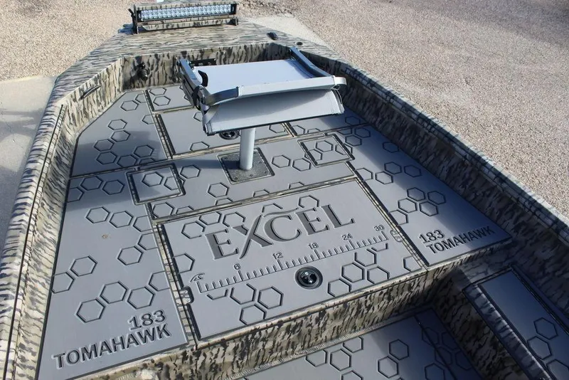 Slide: The Image of 2026 Excel 183 Tomahawk boat deck with hexagonal pattern and mounted accessory. - 26