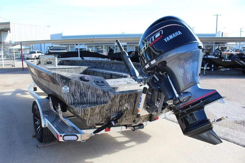 Slide: The Image of 2026 Excel 183 Tomahawk boat with Yamaha engine on trailer, parked outdoors. - 5