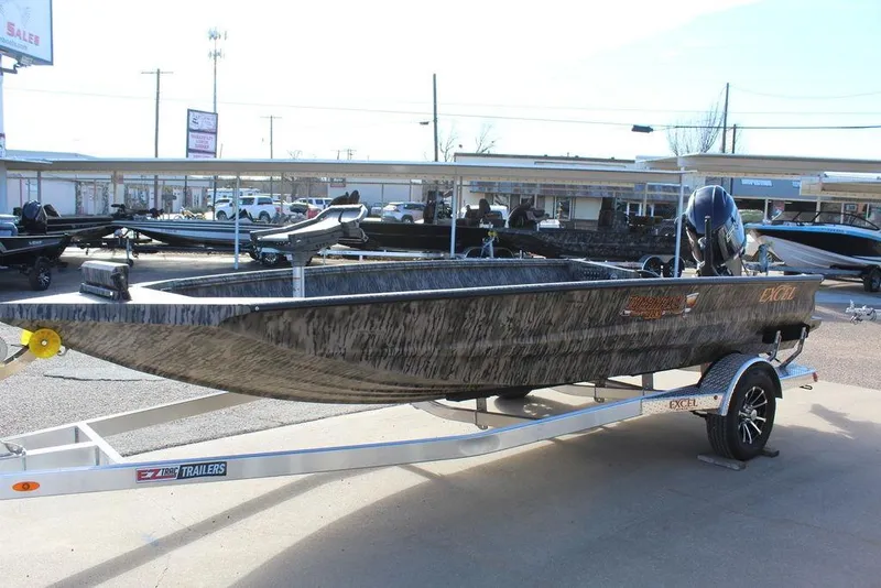 Slide: The Image of 2026 Excel 183 Tomahawk boat on trailer, displayed outdoors at dealership. - 7