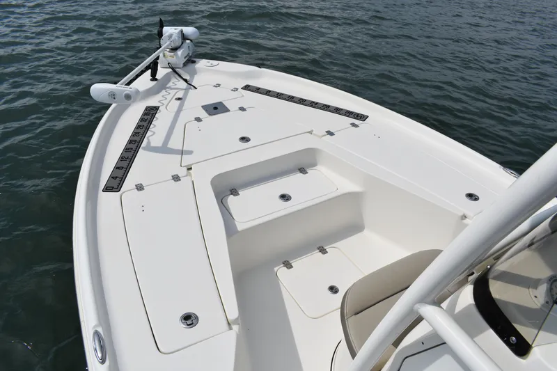 Slide: The Image of 2021 Key West 230 BR boat deck with storage compartments on calm water. - 7