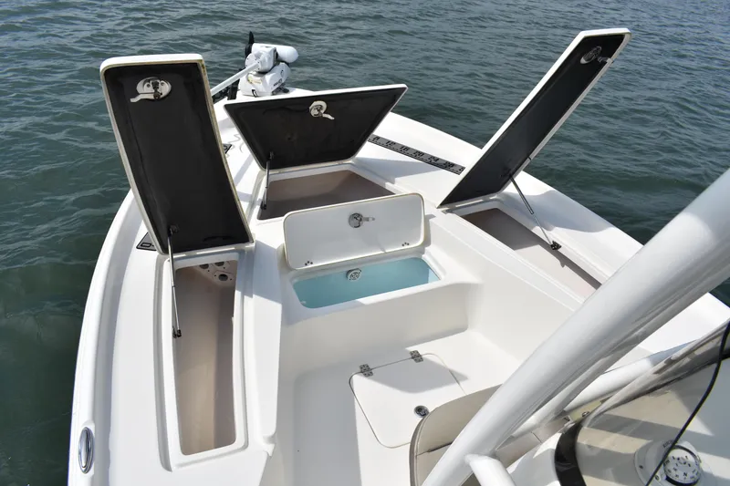 Slide: The Image of 2021 Key West 230 BR boat with open storage compartments on the deck. - 8