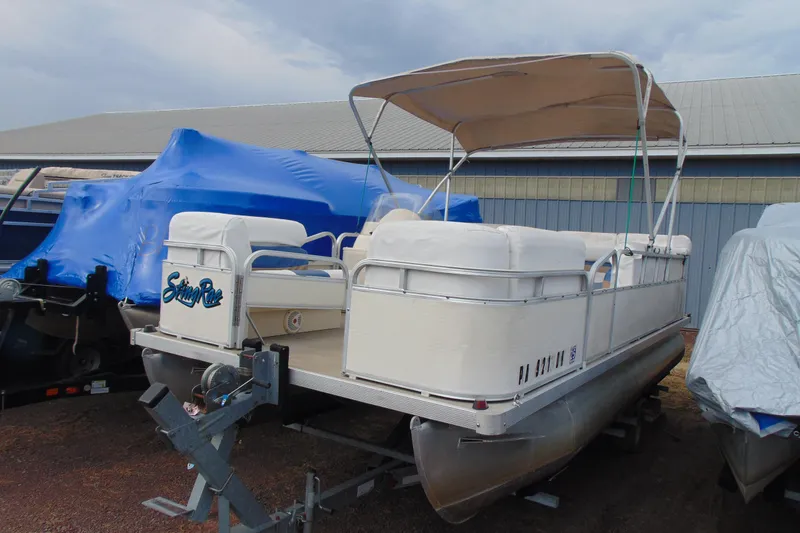 The Image of 2004 Forrest River 1903 pontoon boat with canopy, parked on trailer. - 1