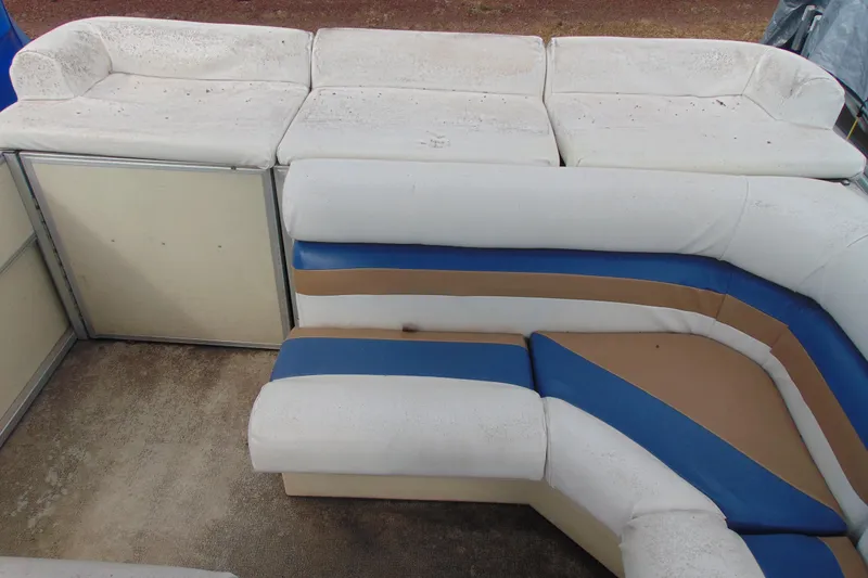 Slide: The Image of 2004 Forrest River 1903 boat interior with white, blue, and brown seating arrangement. - 10
