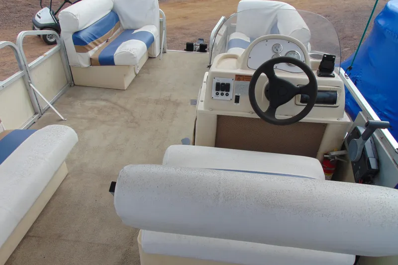 Slide: The Image of Interior of a 2004 Forrest River 1903 boat with seating and steering console. - 11