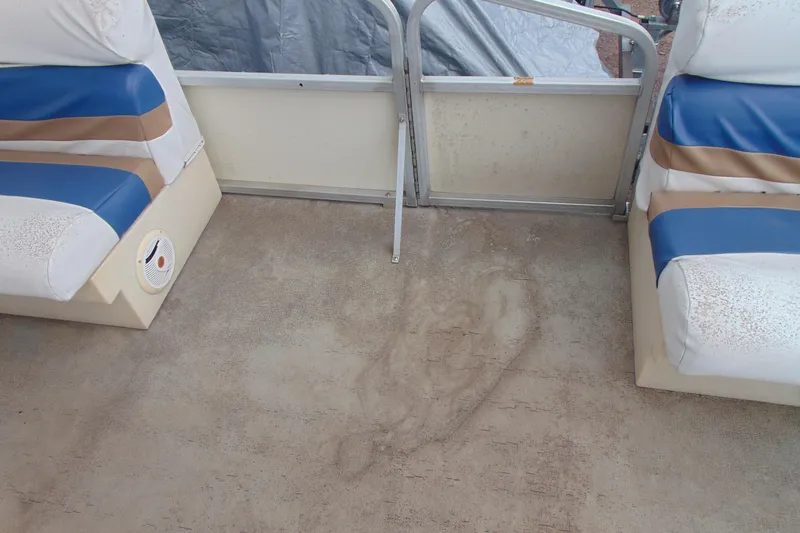 Slide: The Image of Interior of a 2004 Forrest River 1903 boat with blue and brown seating. - 13