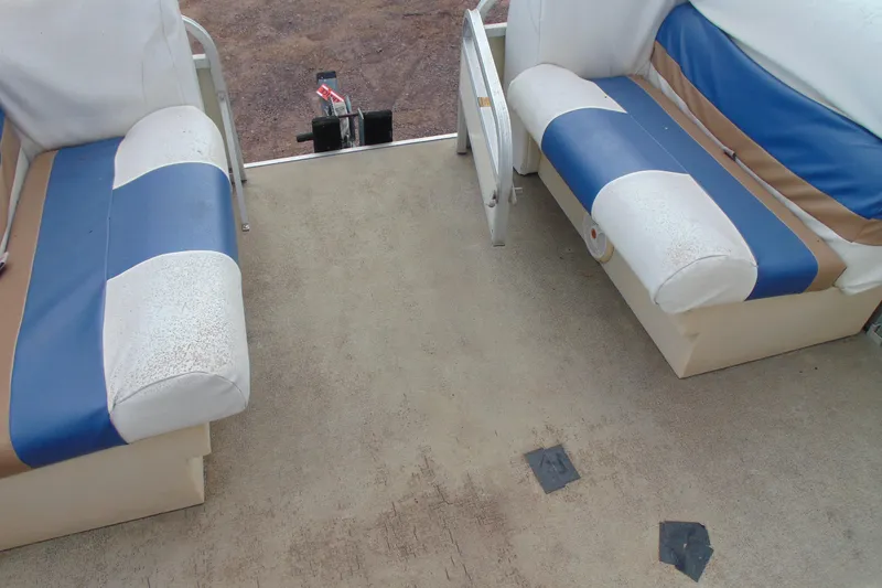 Slide: The Image of Interior of a 2004 Forrest River 1903 boat with blue and white seating. - 15