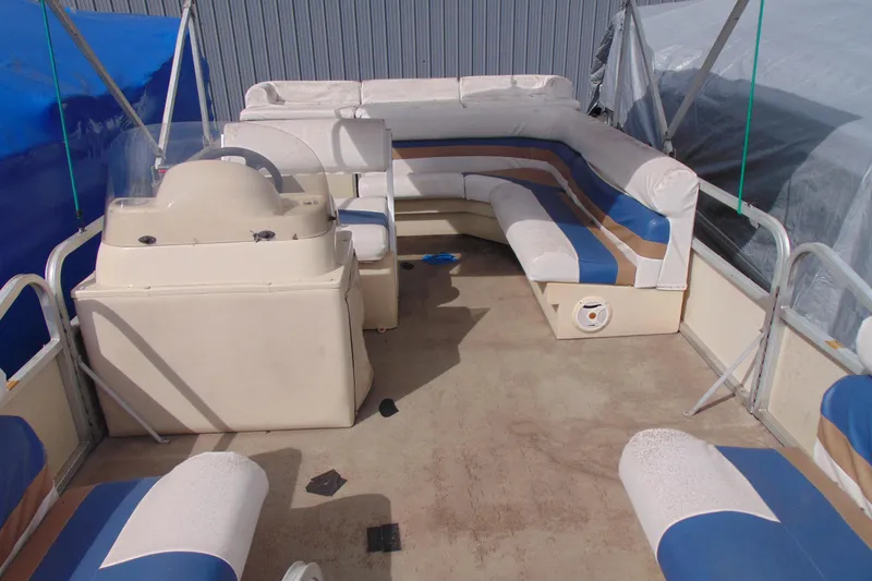 Slide: The Image of 2004 Forrest River 1903 pontoon boat interior with seating and steering console. - 5