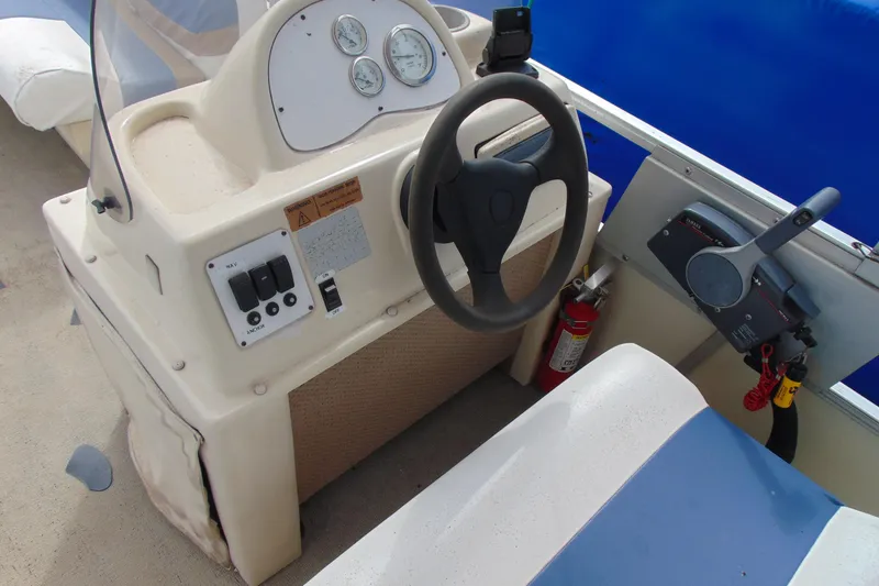 Slide: The Image of Steering console of a 2004 Forrest River 1903 boat with gauges and controls. - 7