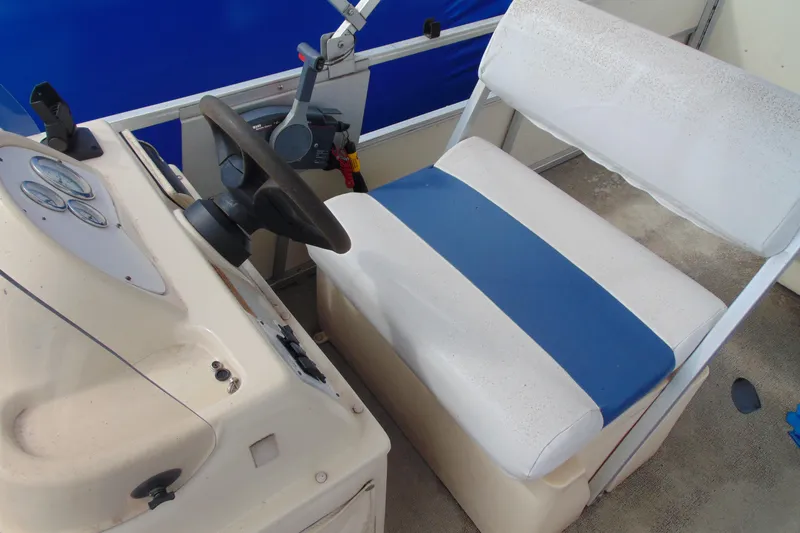 Slide: The Image of Captain's seat and steering console of a 2004 Forrest River 1903 boat. - 8