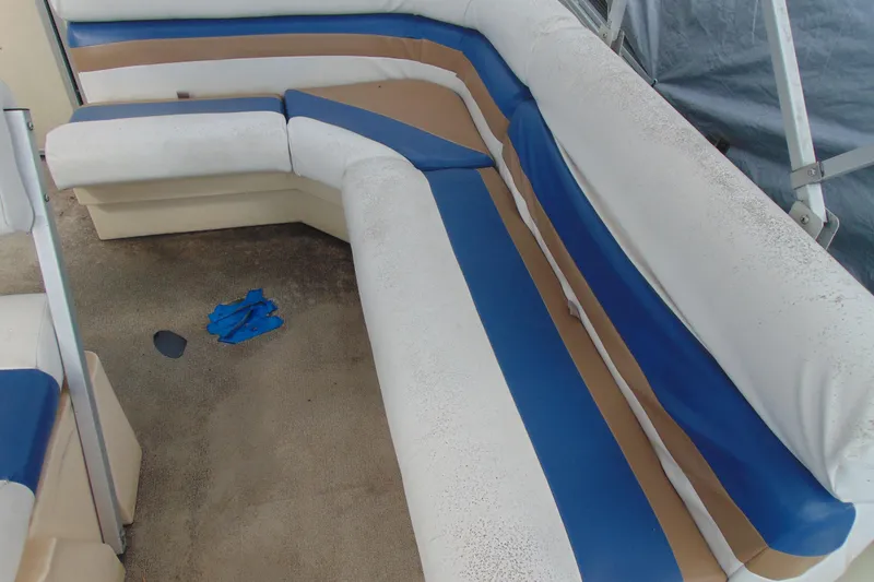Slide: The Image of 2004 Forrest River 1903 boat interior with blue, white, and brown seating. - 9