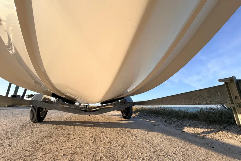 Slide: The Image of Underneath view of a 2010 Boston Whaler 170 Montauk boat on a trailer. - 10
