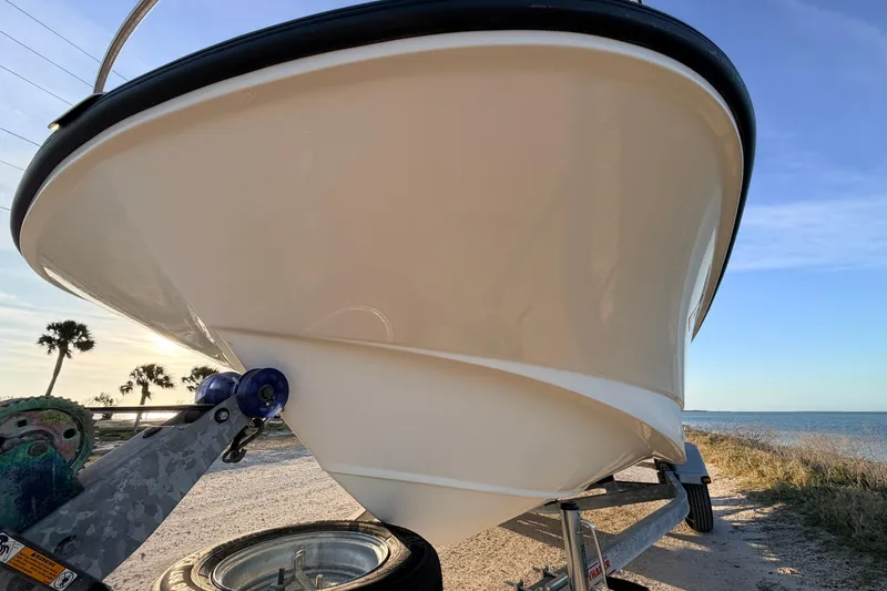 Slide: The Image of 2010 Boston Whaler 170 Montauk boat on trailer by the seaside. - 11