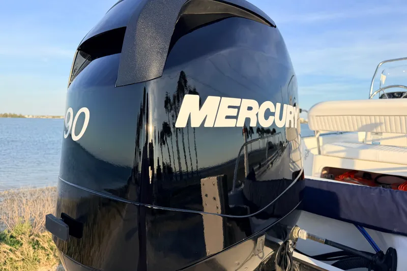 Slide: The Image of Mercury outboard engine on 2010 Boston Whaler 170 Montauk, near water. - 12