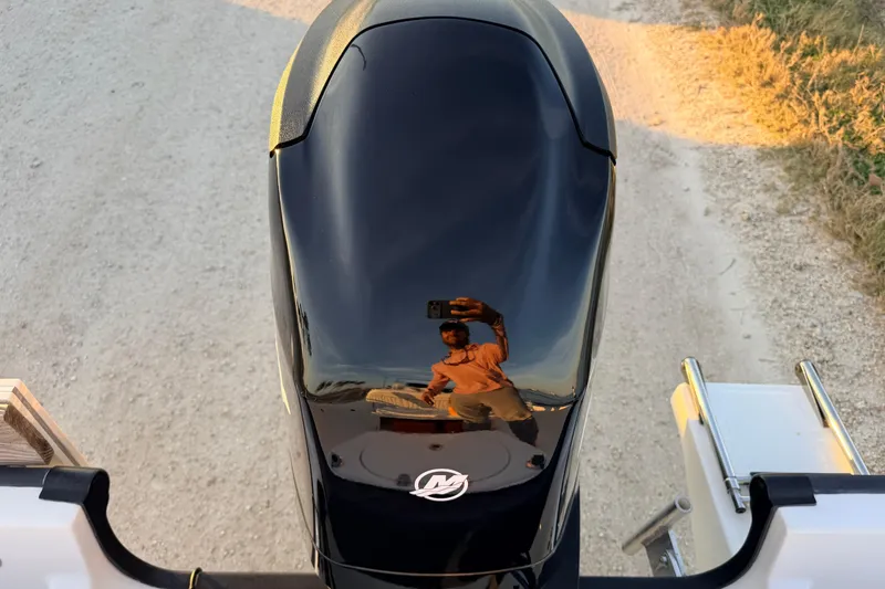 Slide: The Image of Reflection on a 2010 Boston Whaler 170 Montauk boat engine, capturing a person taking a photo. - 14