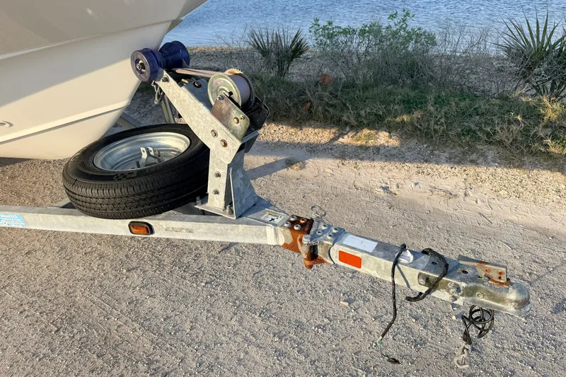 Slide: The Image of Trailer hitch of a 2010 Boston Whaler 170 Montauk by a lakeside. - 15